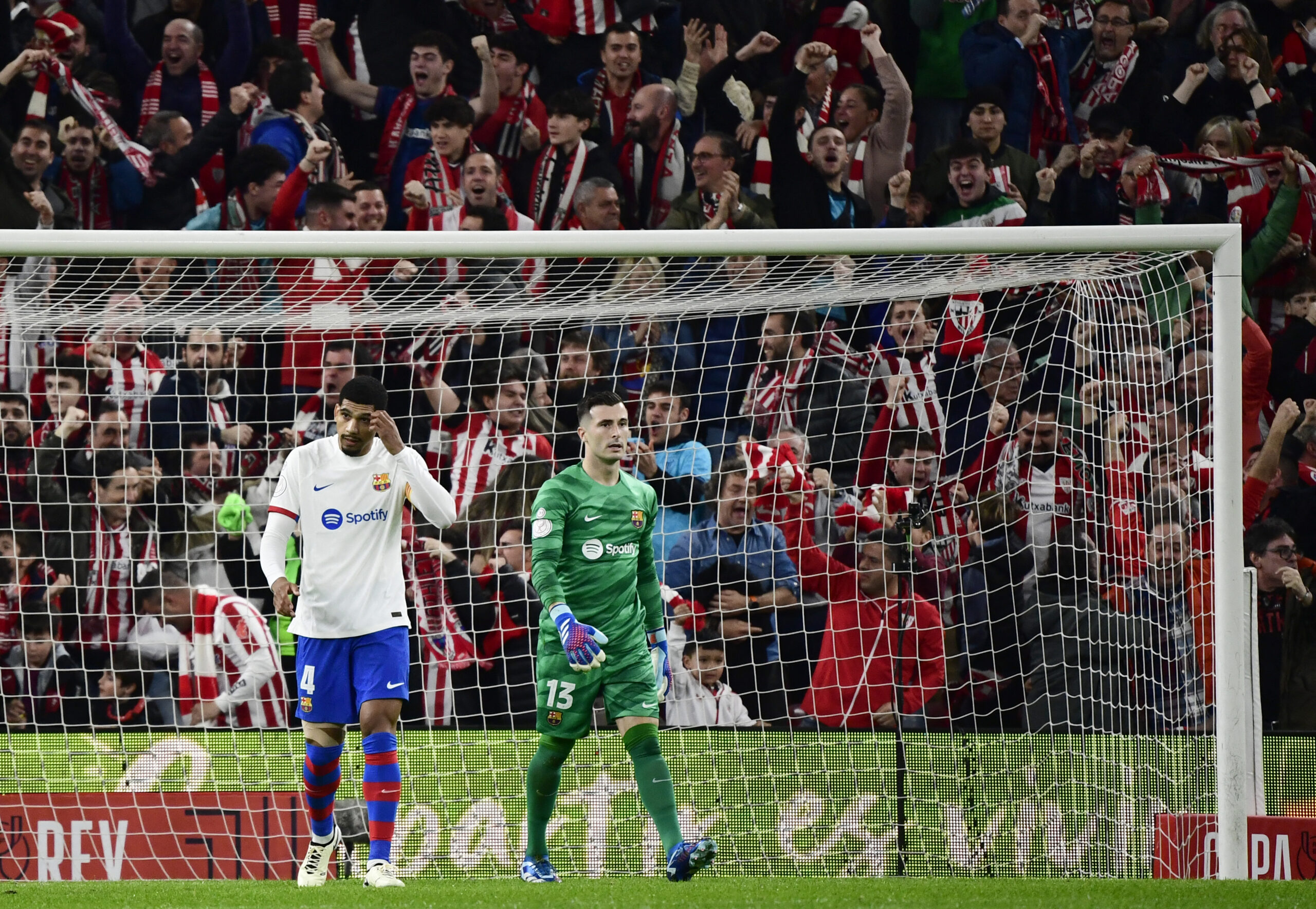 Barcelona's Uruguayan defender #04 Ronald Araujo and Barcelona's Spanish goalkeeper #13 Inaki Pena react to the opening goal scored by Athletic Bilbao's Spanish forward #12 Gorka Guruzeta during the Spanish Copa del Rey (King's Cup) quarter final football match between Athletic Club Bilbao and FC Barcelona at the San Mames stadium in Bilbao on January 24, 2024.