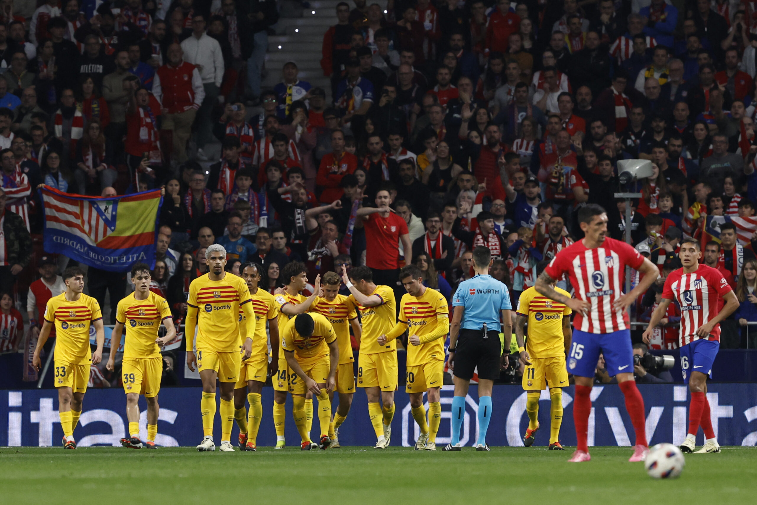 Barcelona's players celebrate the opening goal scored by Portuguese forward #14 Joao Felix celebrates scoring the opening goal during the Spanish league football match between Club Atletico de Madrid and FC Barcelona at the Metropolitano stadium in Madrid on March 17, 2024.