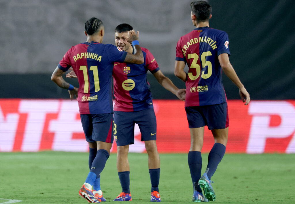 Barcelona's Spanish midfielder #08 Pedri celebrates with Barcelona's Brazilian forward #11 Raphinha scoring his team's first goal during the Spanish league football match between Rayo Vallecano de Madrid and FC Barcelona on August 27, 2024.