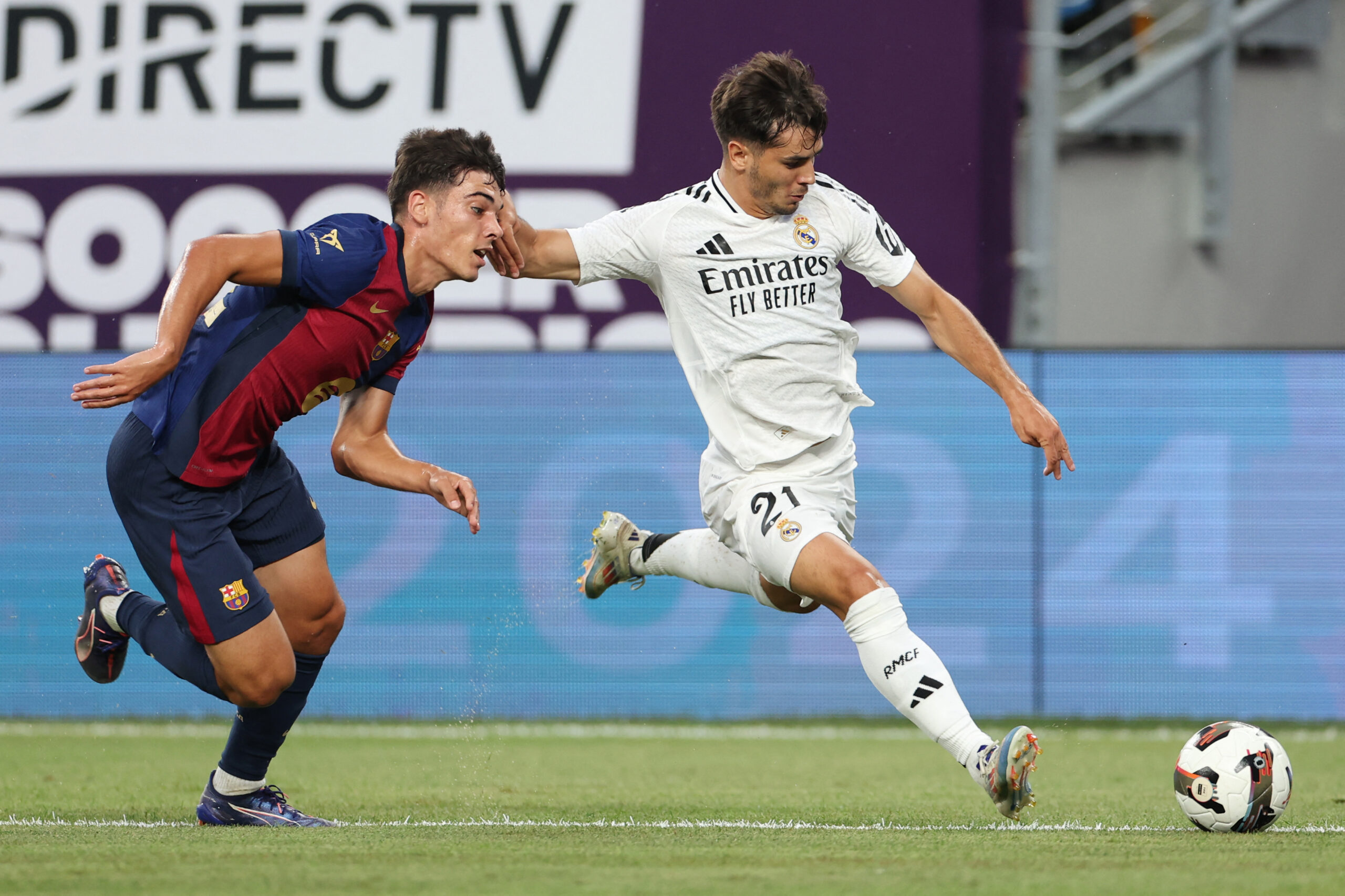 Barcelona's Spanish defender #30 Alex Valle (L) vies for the ball with Real Madrid's Brahim Abdelkader (R) during the pre-season club friendly football match between Real Madrid and FC Barcelona at MetLife Stadium, in East Rutherford, New Jersey on August 3, 2024. (Photo by Charly TRIBALLEAU / AFP) (Photo by CHARLY TRIBALLEAU/AFP via Getty Images)