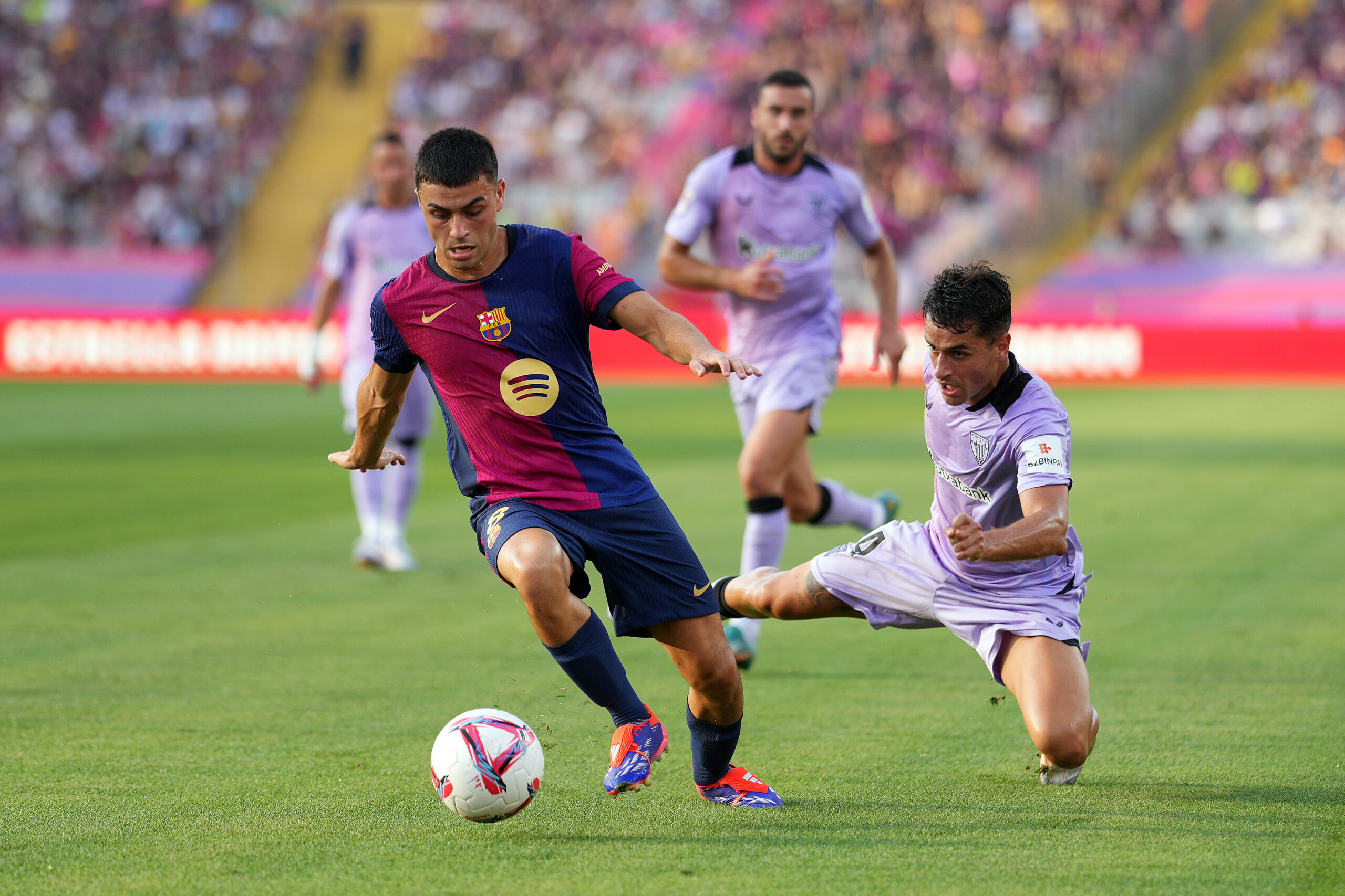 BARCELONA, SPAIN - AUGUST 24: Pedri of FC Barcelona is challenged by Benat Prados of Athletic Club during the La Liga match between FC Barcelona and Athletic Club at Camp Nou on August 24, 2024 in Barcelona, Spain.