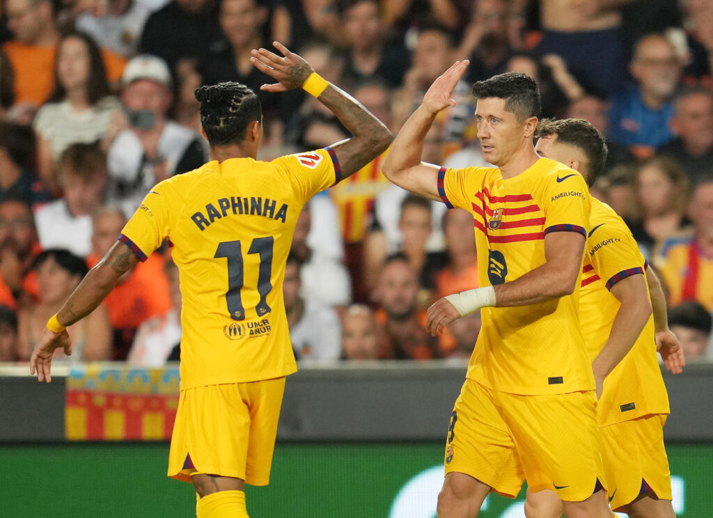 VALENCIA, SPAIN - AUGUST 17: Robert Lewandowski of FC Barcelona celebrates scoring his team's second goal from a penalty kick with teammate Raphinha during the La Liga match between Valencia CF and FC Barcelona at Estadio Mestalla on August 17, 2024 in Valencia, Spain.