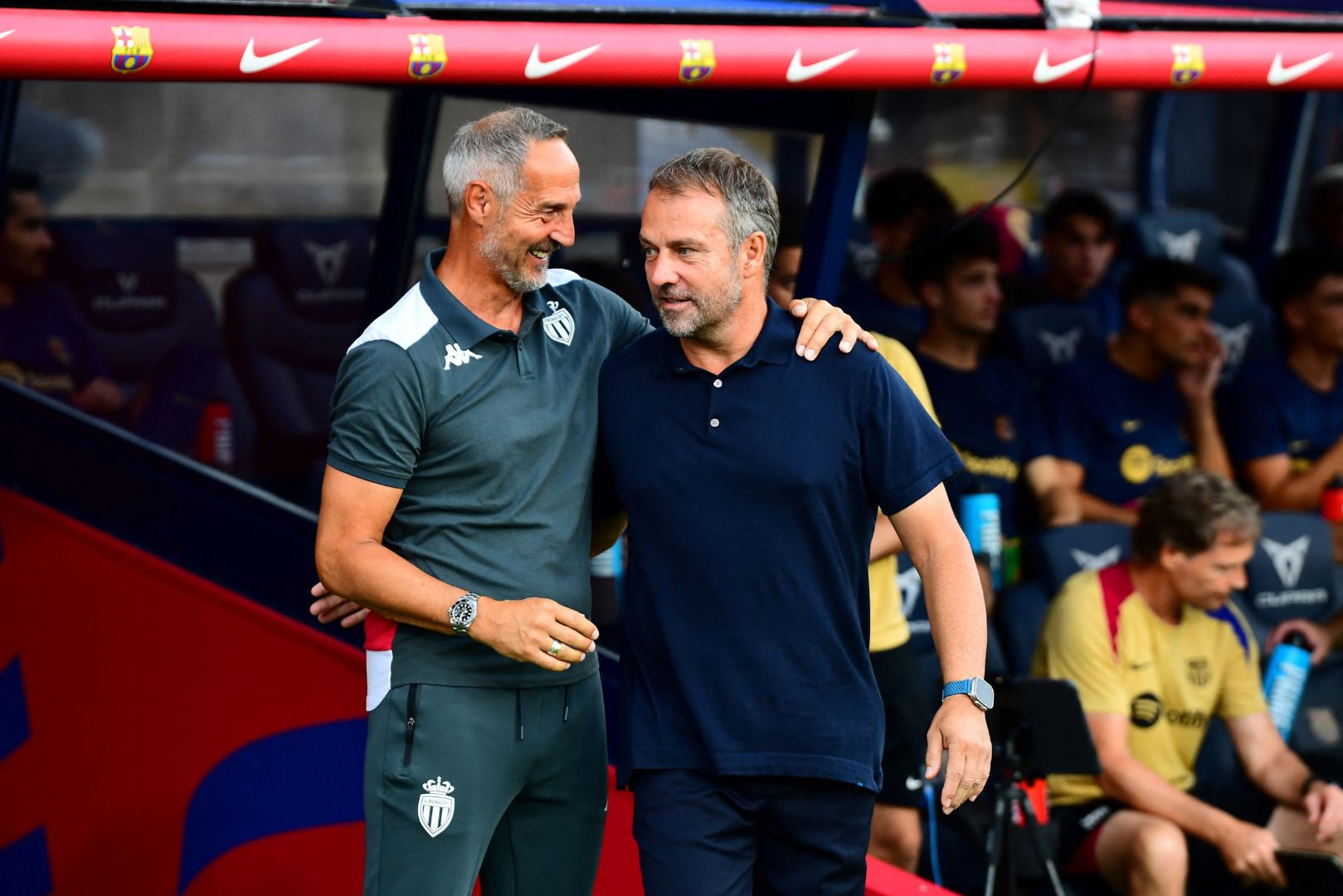 Monaco's Austrian head coach Adi Hutter greets Barcelona's German coach Hansi Flick (R) prior the 59th Joan Gamper Trophy football match between FC Barcelona and AS Monaco at the Estadi Olimpic Lluis Companys in Barcelona on August 12, 2024.