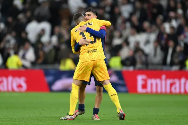 MADRID, SPAIN - OCTOBER 26: Inaki Pena and Pedri of FC Barcelona celebrate victory following the LaLiga match between Real Madrid CF and FC Barcelona at Estadio Santiago Bernabeu on October 26, 2024 in Madrid, Spain.