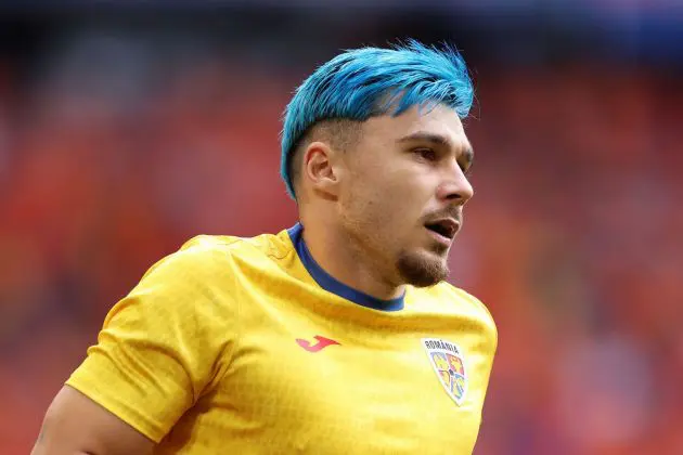 MUNICH, GERMANY - JULY 02: Andrei Ratiu of Romania looks on as he warms up, as his blue dyed hair can be seen, prior to the UEFA EURO 2024 round of 16 match between Romania and Netherlands at Munich Football Arena on July 02, 2024 in Munich, Germany.