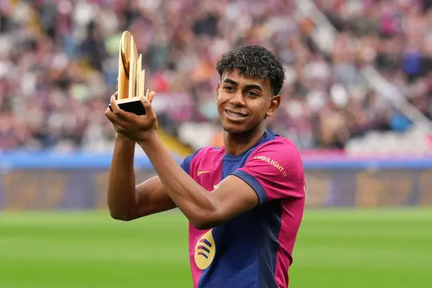 BARCELONA, SPAIN - NOVEMBER 03: Lamine Yamal of FC Barcelona acknowledges the fans as he displays his 2024 Kopa Trophy prior to the La Liga EA Sports match between FC Barcelona and RCD Espanyol at Estadi Olimpic Lluis Companys on November 03, 2024 in Barcelona, Spain.