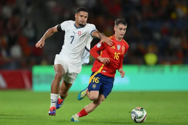 SANTA CRUZ DE TENERIFE, SPAIN - NOVEMBER 18: Marc Casado of Spain is challenged by Simon Sohm of Switzerland during the UEFA Nations League 2024/25 League A Group A4 match between Spain and Switzerland at El Heliodoro Rodriguez Lopez stadium on November 18, 2024 in Santa Cruz de Tenerife, Spain.