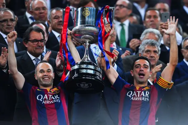 BARCELONA, SPAIN - MAY 30: FC Barcelona players Andres Iniesta (L) and Xavi Hernandez of FC Barcelona celebrate with the trophy after winning the Copa del Rey Final match between FC Barcelona and Athletic Club at Camp Nou on May 30, 2015 in Barcelona, Spain.