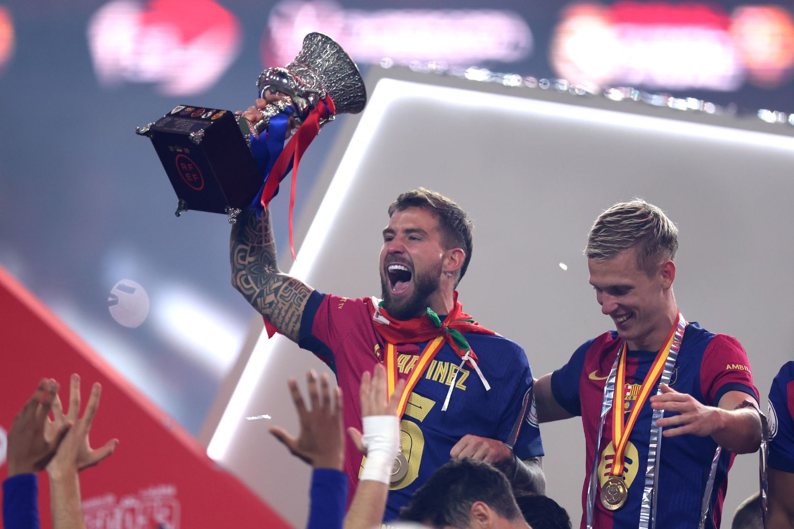 JEDDAH, SAUDI ARABIA - JANUARY 12: Inigo Martinez of FC Barcelona celebrates with the Supercopa de Espana winners' trophy during the trophy presentation after the Spanish Super Cup Final between Real Madrid and FC Barcelona at King Abdullah Sports City on January 12, 2025 in Jeddah, Saudi Arabia.