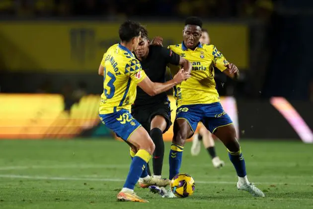 LAS PALMAS, SPAIN - FEBRUARY 22: Lamine Yamal of FC Barcelona is challenged by Alex Munoz and Dario Essugo of UD Las Palmas during the LaLiga match between UD Las Palmas and FC Barcelona at Estadio Gran Canaria on February 22, 2025 in Las Palmas, Spain.