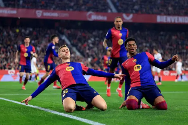 SEVILLE, SPAIN - FEBRUARY 09: Fermin Lopez of FC Barcelona celebrates scoring his team's second goal with teammate Alejandro Balde during the LaLiga match between Sevilla FC and FC Barcelona at Estadio Ramon Sanchez Pizjuan on February 09, 2025 in Seville, Spain.