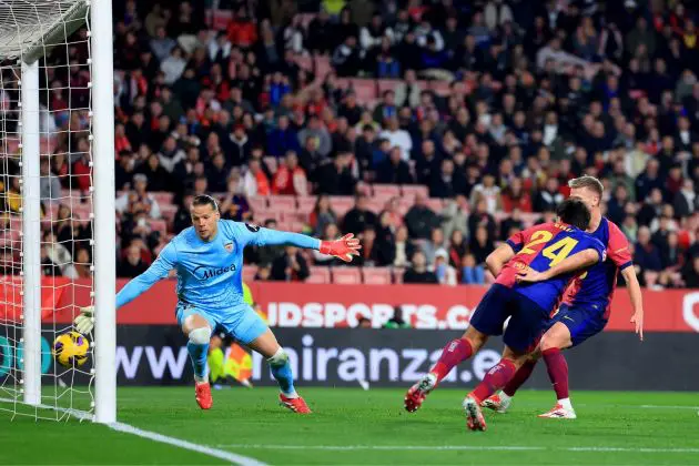 SEVILLE, SPAIN - FEBRUARY 09: Eric Garcia of FC Barcelona scores his team's fourth goal with a header as Oerjan Nyland of Sevilla FC fails to make a save during the LaLiga match between Sevilla FC and FC Barcelona at Estadio Ramon Sanchez Pizjuan on February 09, 2025 in Seville, Spain.