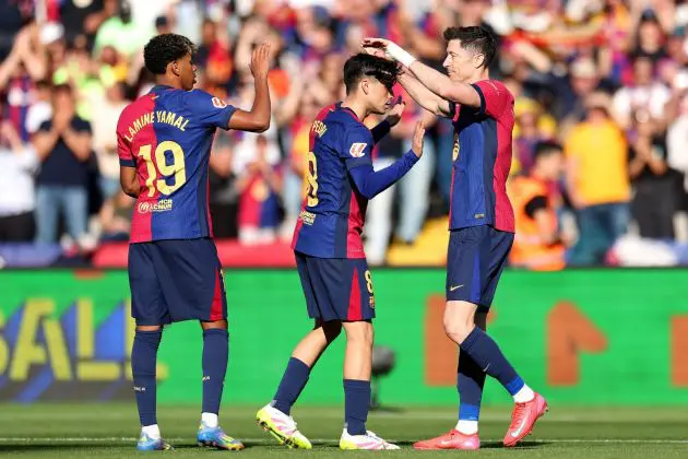 BARCELONA, SPAIN - MARCH 30: Robert Lewandowski of FC Barcelona (R) celebrates scoring his team's third goal with teammates Pedri and Lamine Yamal during the La Liga EA Sports match between FC Barcelona and Girona FC at Estadi Olimpic Lluis Companys on March 30, 2025 in Barcelona, Spain.