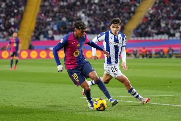 BARCELONA, SPAIN - MARCH 02: Lamine Yamal of FC Barcelona controls the ball whilst under pressure from Pablo Marin of Real Sociedad during the La Liga EA match between FC Barcelona and Real Sociedad at Estadi Olimpic Lluis Companys on March 02, 2025 in Barcelona, Spain.
