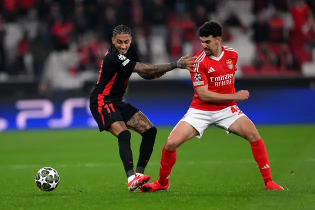 LISBON, PORTUGAL - MARCH 05: Raphinha of FC Barcelona battles for possession with Tomas Araujo of SL Benfica during the UEFA Champions League 2024/25 Round of 16 first Leg match between SL Benfica and FC Barcelona at Estadio da Luz on March 05, 2025 in Lisbon, Portugal.