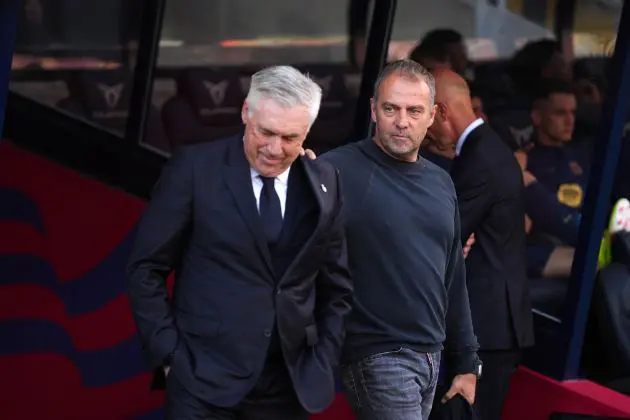 BARCELONA, SPAIN - MAY 11: Hansi Flick, Head Coach of FC Barcelona, places a hand on the shoulder of Carlo Ancelotti, Head Coach of Real Madrid, prior to the LaLiga match between FC Barcelona and Real Madrid CF at Estadi Olimpic Lluis Companys on May 11, 2025 in Barcelona, Spain.