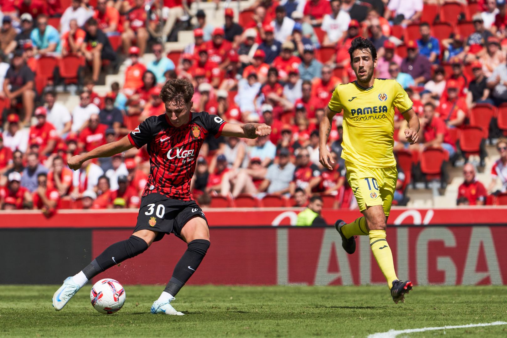 MALLORCA, SPAIN - SEPTEMBER 14: Marc Domenech of RCD Mallorca shoots the ball during the LaLiga match between RCD Mallorca and Villarreal CF at Estadi de Son Moix on September 14, 2024 in Mallorca, Spain.
