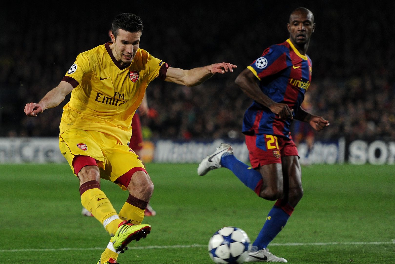 BARCELONA, SPAIN - MARCH 08: Robin van Persie (L) of Arsenal shoots on goal from offside position past Eric Abidal of Barcelona during the UEFA Champions League round of 16 second leg match between Barcelona and Arsenal on March 8, 2011 in Barcelona, Spain. Van Persie received a second yellow card for the foul and was send off.