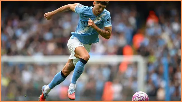 MANCHESTER, ENGLAND - AUGUST 23: John Stones of Manchester City runs with the ball during the Premier League match between Manchester City and Tottenham Hotspur at Etihad Stadium on August 23, 2025 in Manchester, England.