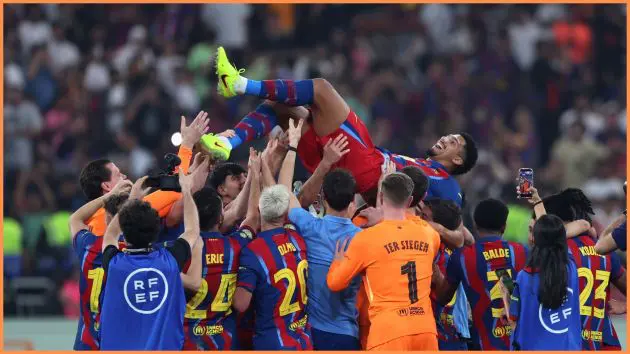 JEDDAH, SAUDI ARABIA - JANUARY 11: FC Barcelona players throw Ronald Araujo of FC Barcelona in the air following their side's victory in the Spanish Super Cup Final between FC Barcelona and Real Madrid at King Abdullah Sports City Hall Stadium on January 11, 2026 in Jeddah, Saudi Arabia.