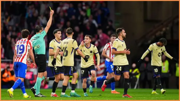 MADRID, SPAIN - FEBRUARY 12: Marc Casado of FC Barcelona is shown a yellow card by referee Juan Martinez Munuera during the Copa Del Rey Semi-Final First Leg match between Atletico de Madrid and FC Barcelona at Riyadh Air Metropolitano on February 12, 2026 in Madrid, Spain.