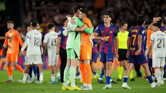 BARCELONA, SPAIN - MAY 10: Thibaut Courtois of Real Madrid embraces Joan Garcia of FC Barcelona after FC Barcelona defeat Real Madrid, and win the LaLiga title, after the LaLiga EA Sports match between FC Barcelona and Real Madrid CF at Spotify Camp Nou on May 10, 2026 in Barcelona, Spain.
