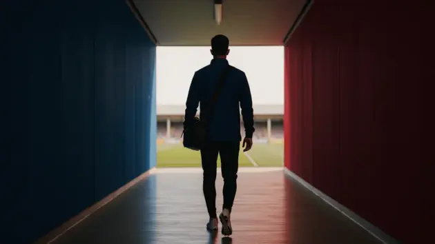 Footballer walking through stadium tunnel with blue and red lighting symbolizing Barcelona departure