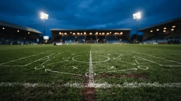 Tactical soccer formation on training pitch with blue evening light and midfield focus