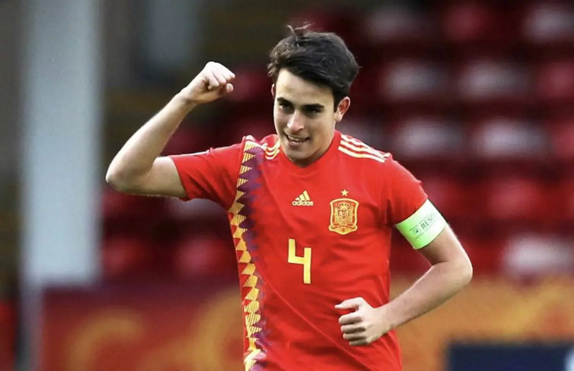 Eric Garcia wearing a red Spain national team football jersey with number 4, celebrating on the pitch