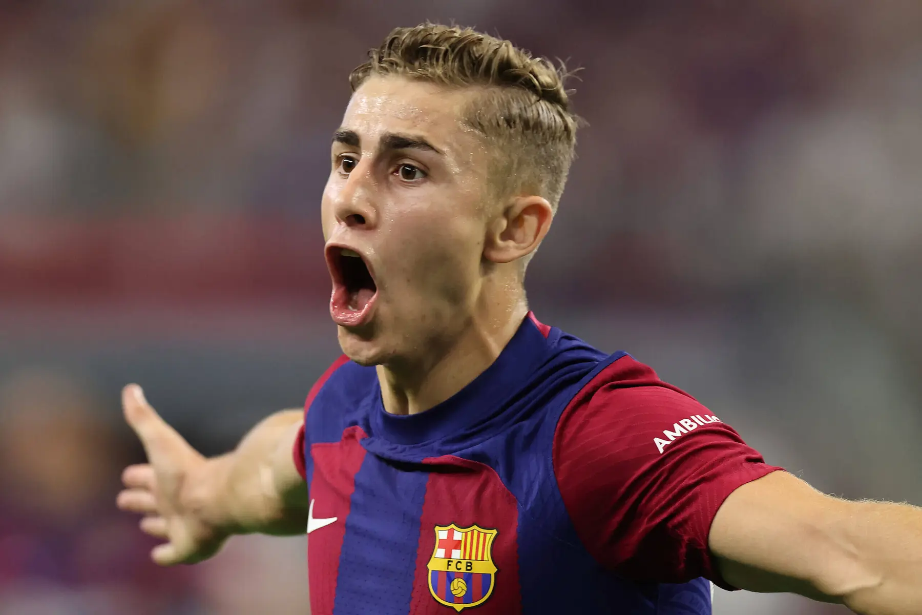 Fermin Lopez celebrating in FC Barcelona jersey during a match.