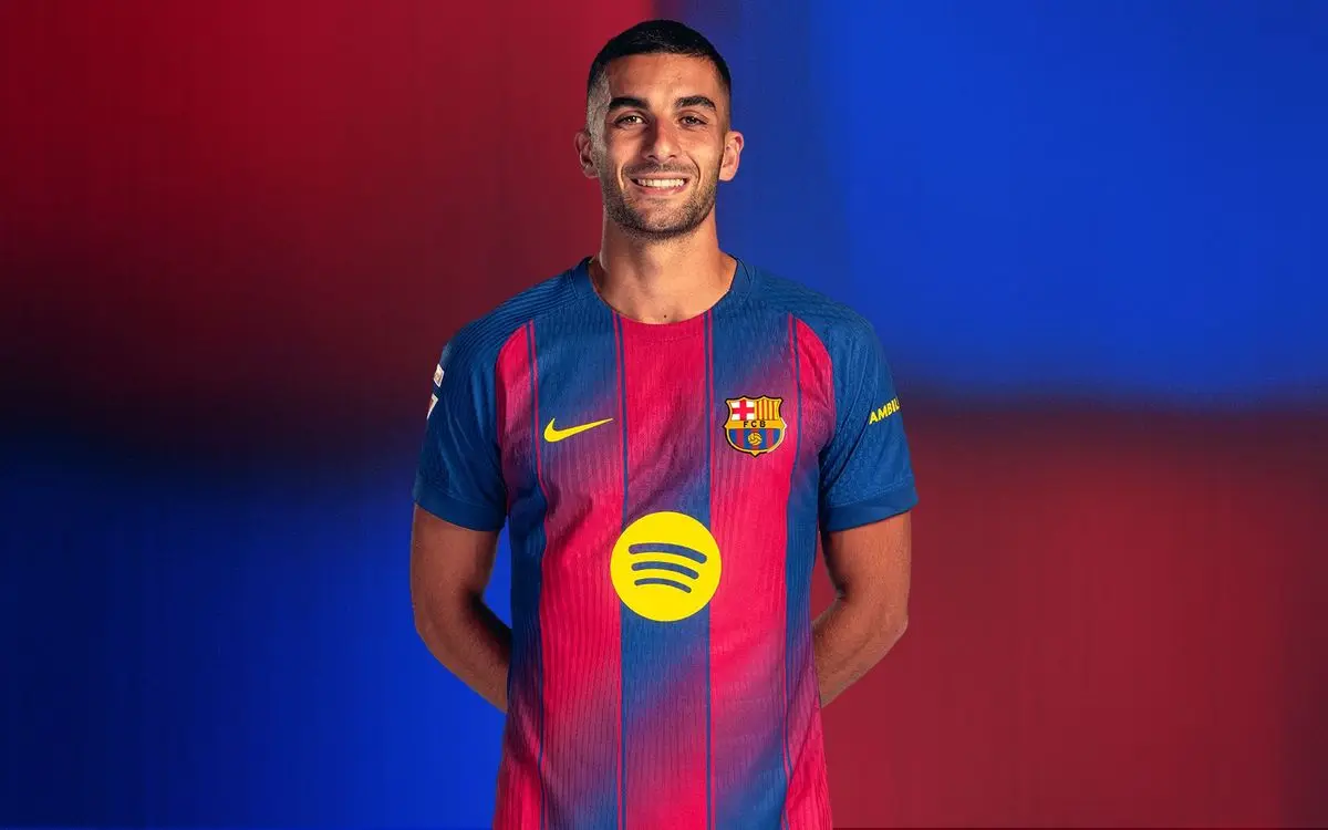 Ferran Torres in a Barcelona jersey with a blue and red background.