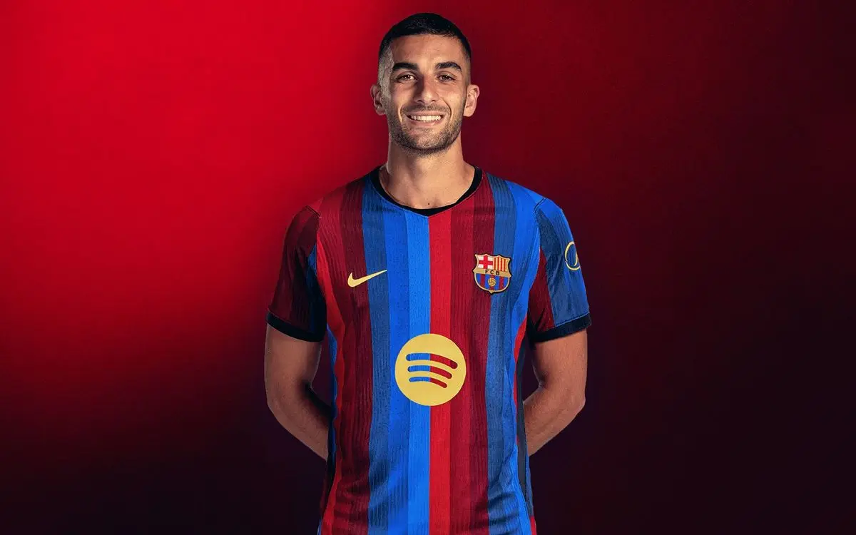 Ferran Torres wearing the FC Barcelona home kit against a red background
