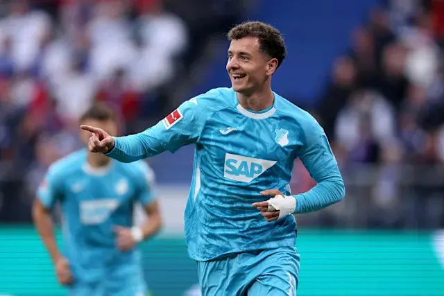 Fisnik Asllani in a light blue TSG Hoffenheim kit celebrating on a football pitch