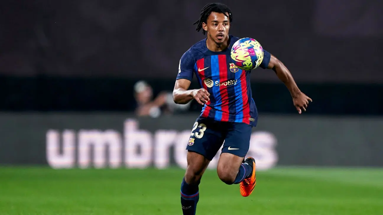 Jules Kounde in a Barcelona jersey dribbling the football during a match.