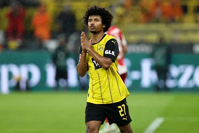 Karim Adeyemi in Borussia Dortmund's yellow jersey, on the field during a match.