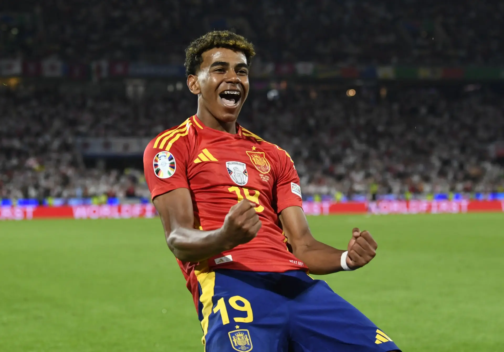 Lamine Yamal celebrating in Spain national football team jersey during a match.