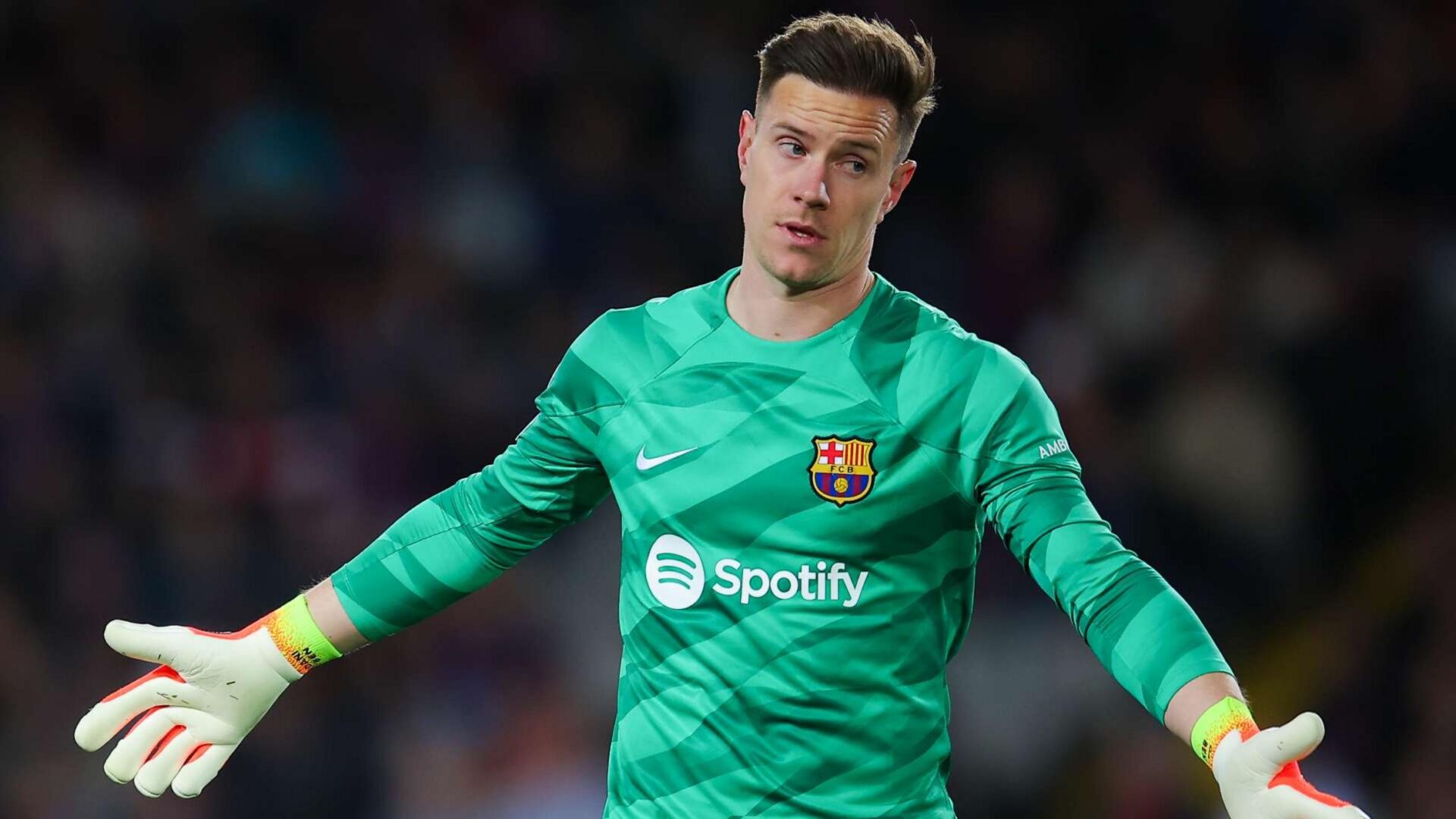 Marc-André ter Stegen in a Barcelona goalkeeper kit gesturing on the field.