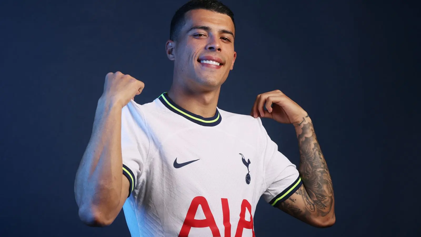 Pedro Porro wearing a Tottenham Hotspur jersey, smiling and posing.