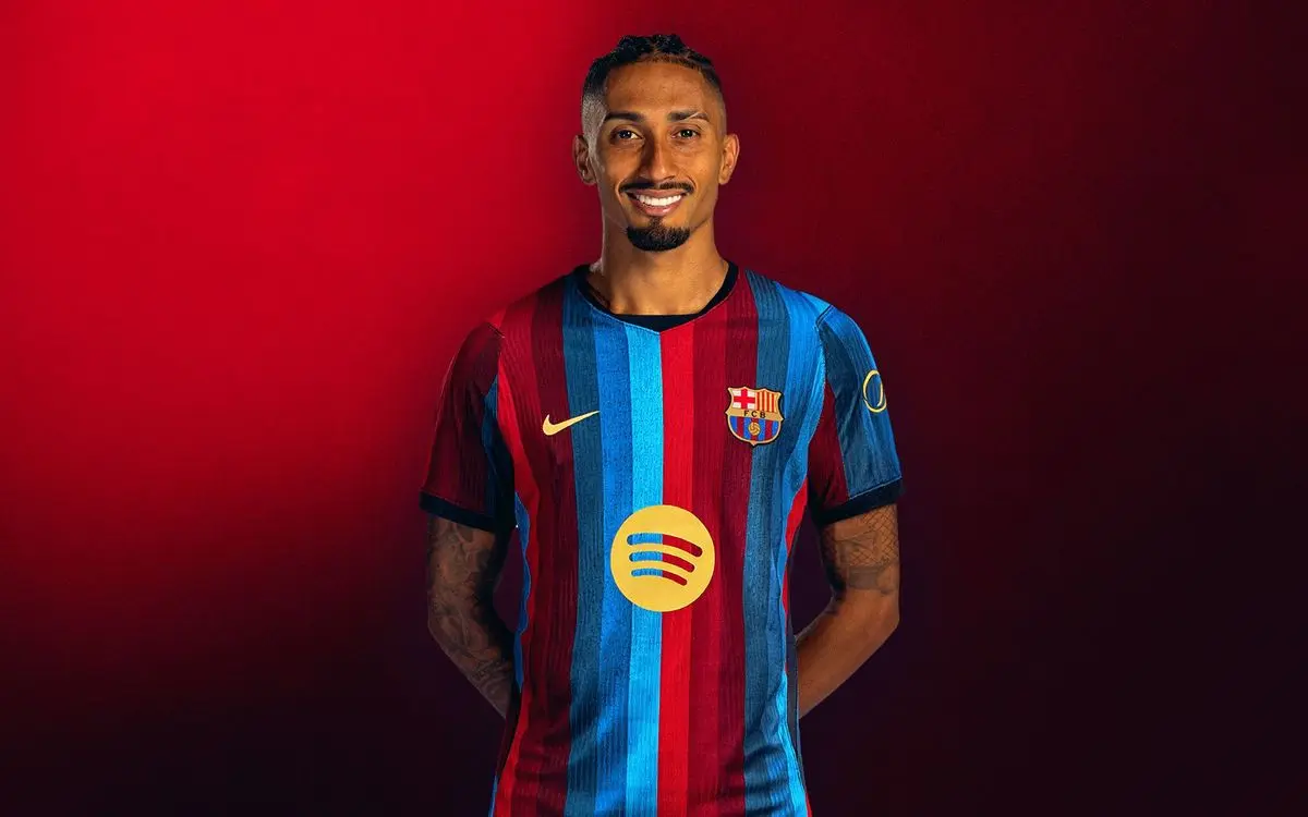 Raphinha wearing FC Barcelona's striped jersey against a red background.