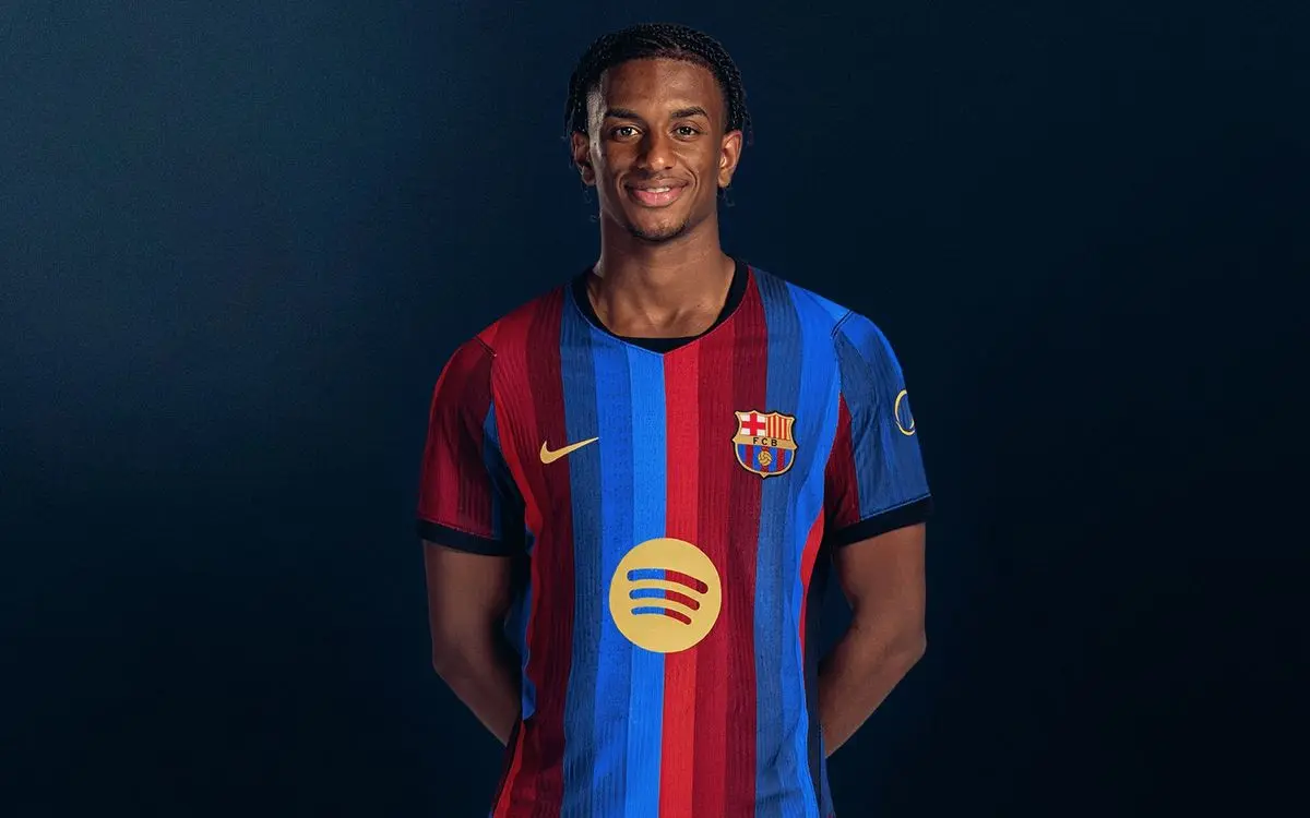Alejandro Balde posing in the FC Barcelona home kit against a dark blue background