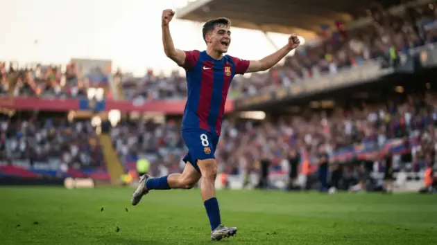 Young footballer in Barcelona jersey celebrating goal during pre-season match