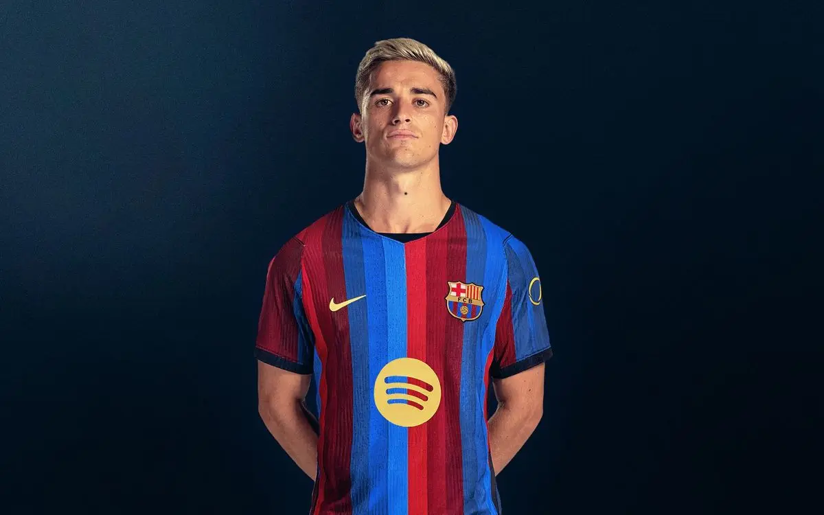 Gavi wearing a blue and red striped FC Barcelona jersey posing against a dark blue background
