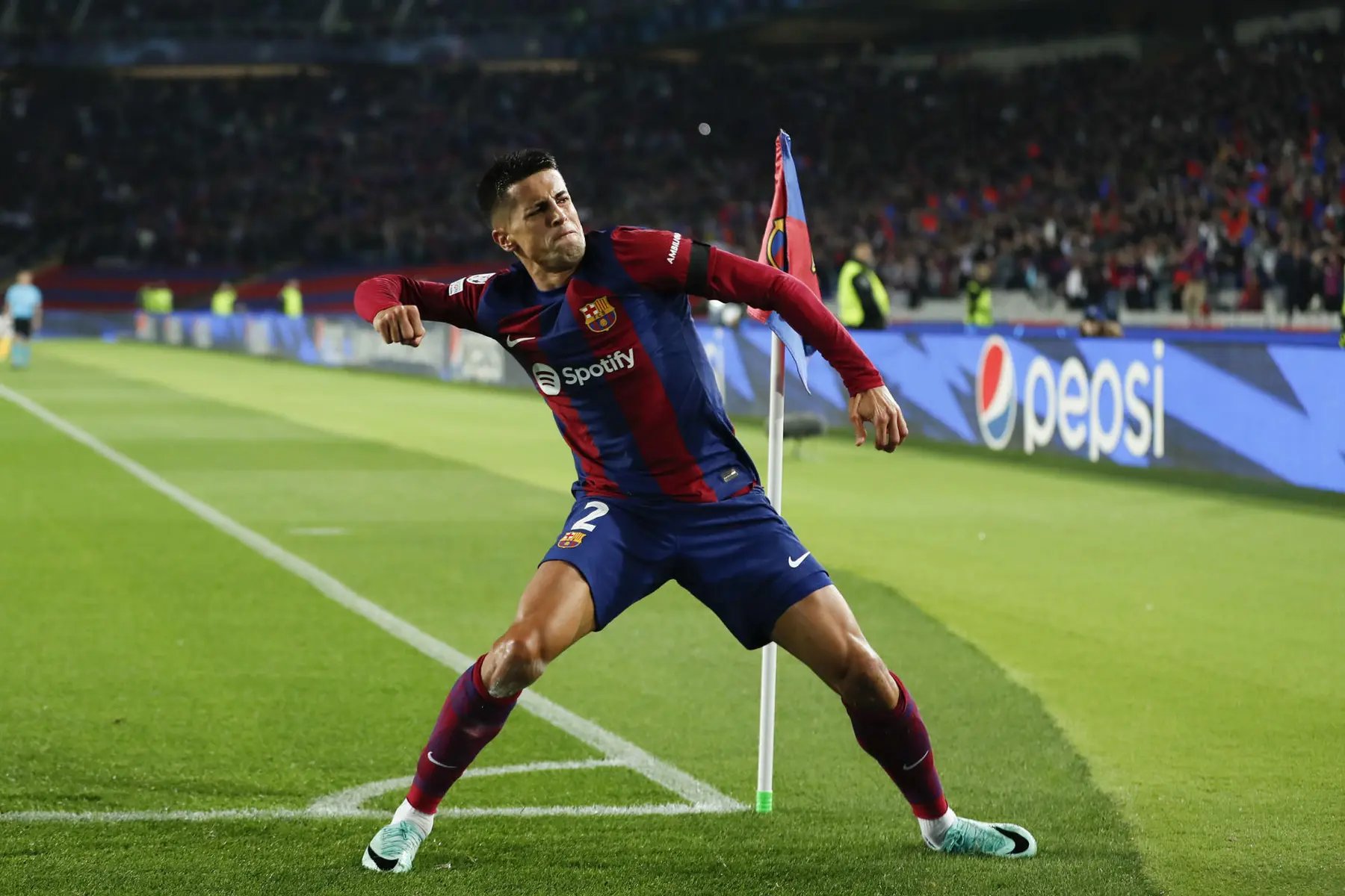 Joao Cancelo in a FC Barcelona home kit standing on the pitch during a match