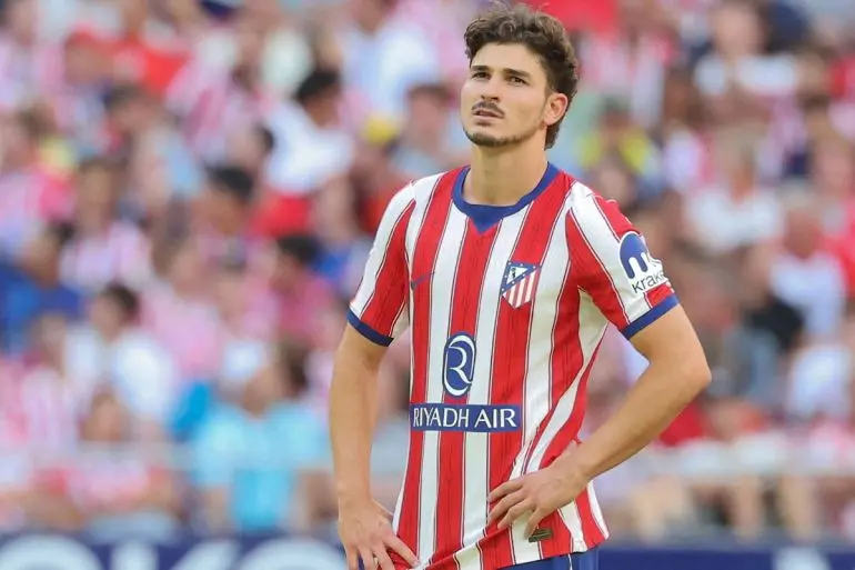 Julian Alvarez wearing the red and white striped Atletico Madrid home kit during a match