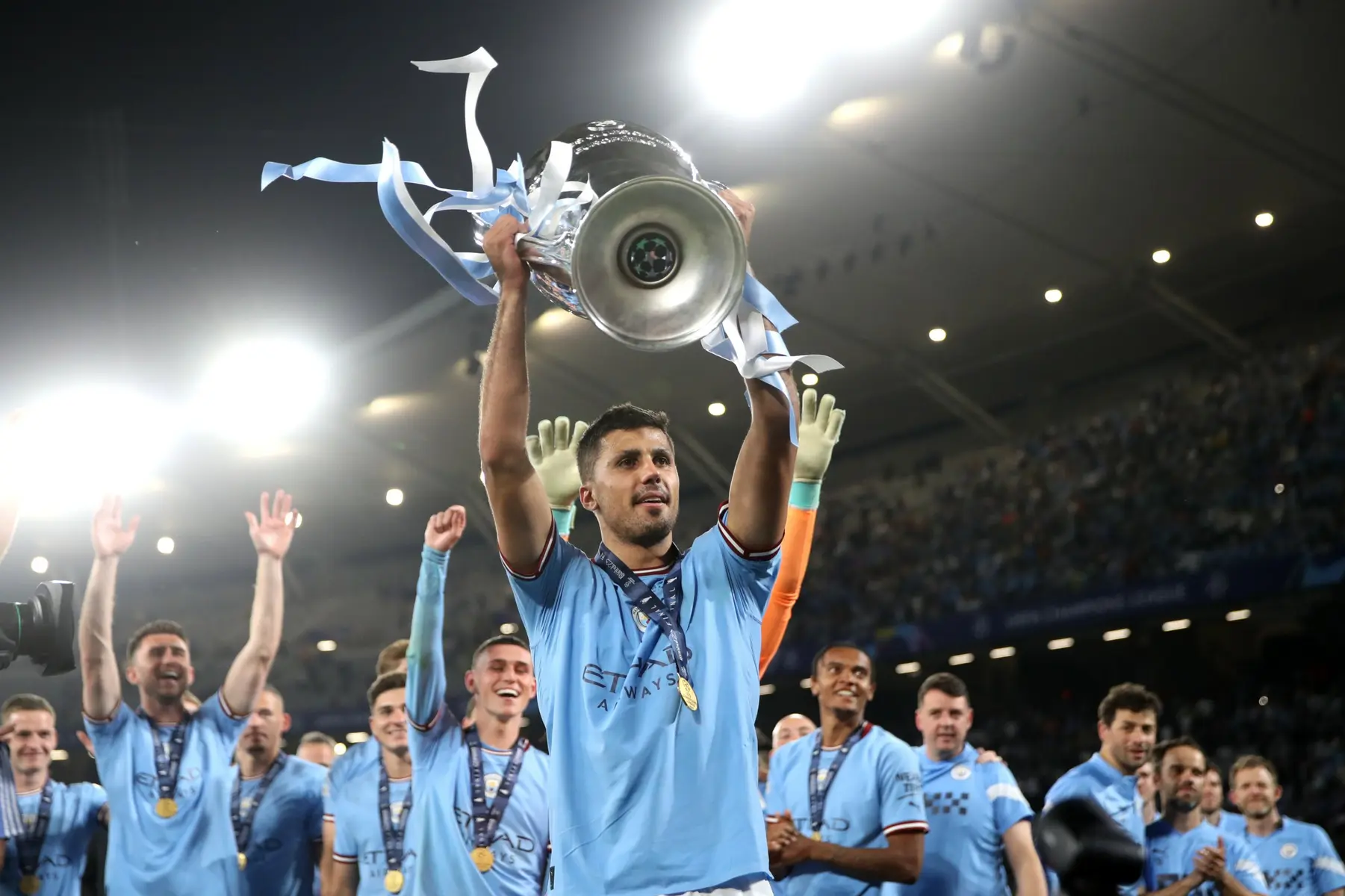 Rodri of Manchester City lifting the UEFA Champions League trophy above his head during celebrations