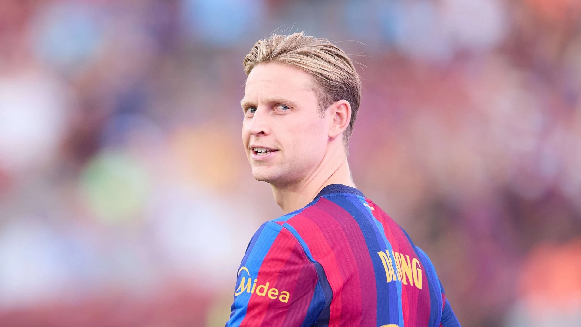 Frenkie de Jong wearing an FC Barcelona jersey on a football pitch.
