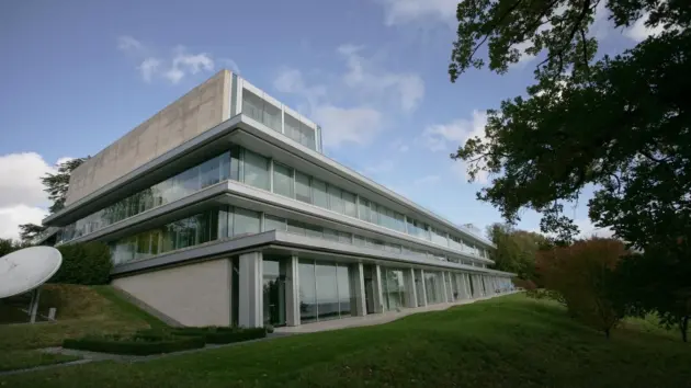 The modern glass and concrete architecture of the UEFA House of European Football headquarters.