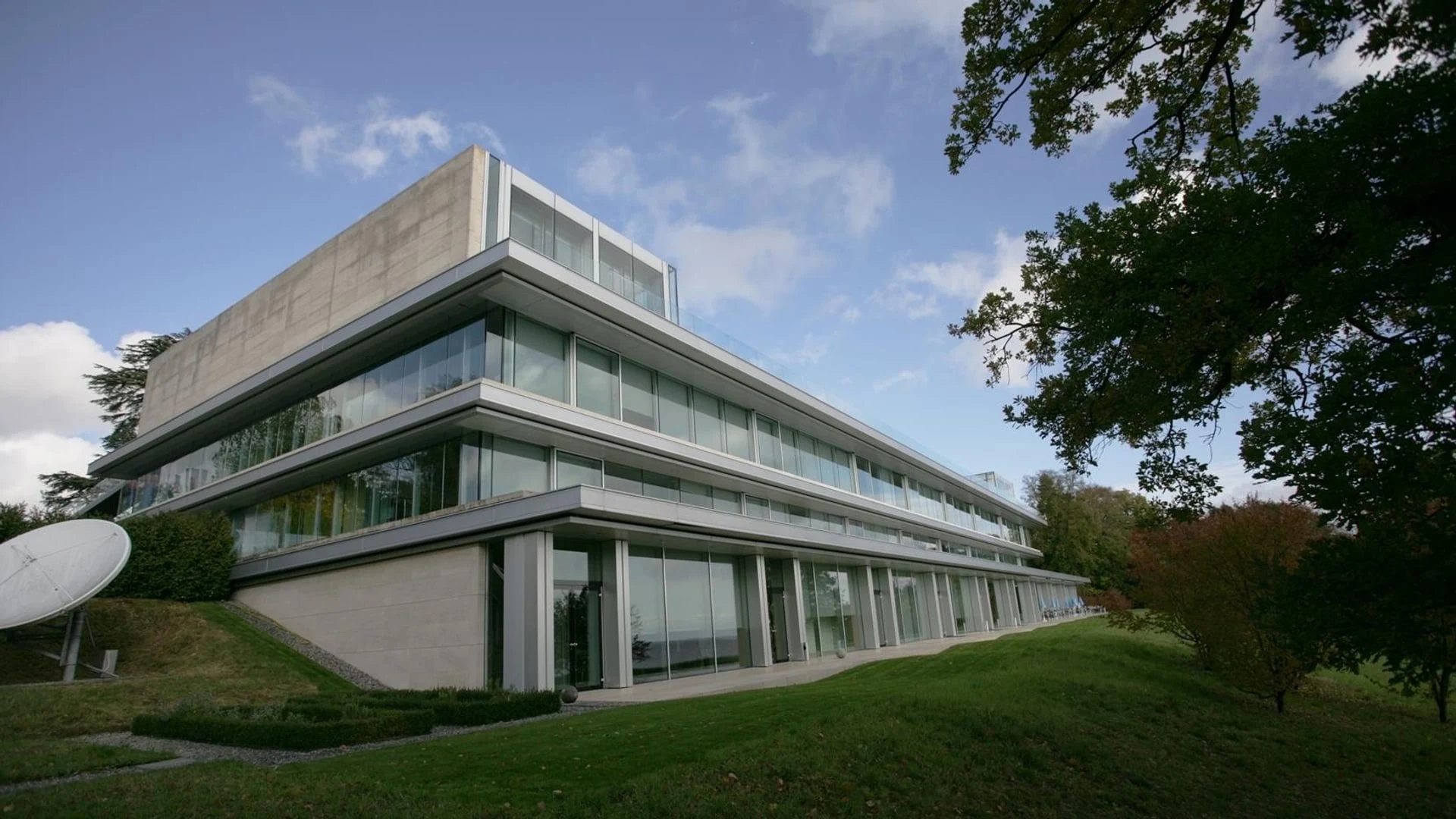 The modern glass and concrete architecture of the UEFA House of European Football headquarters.