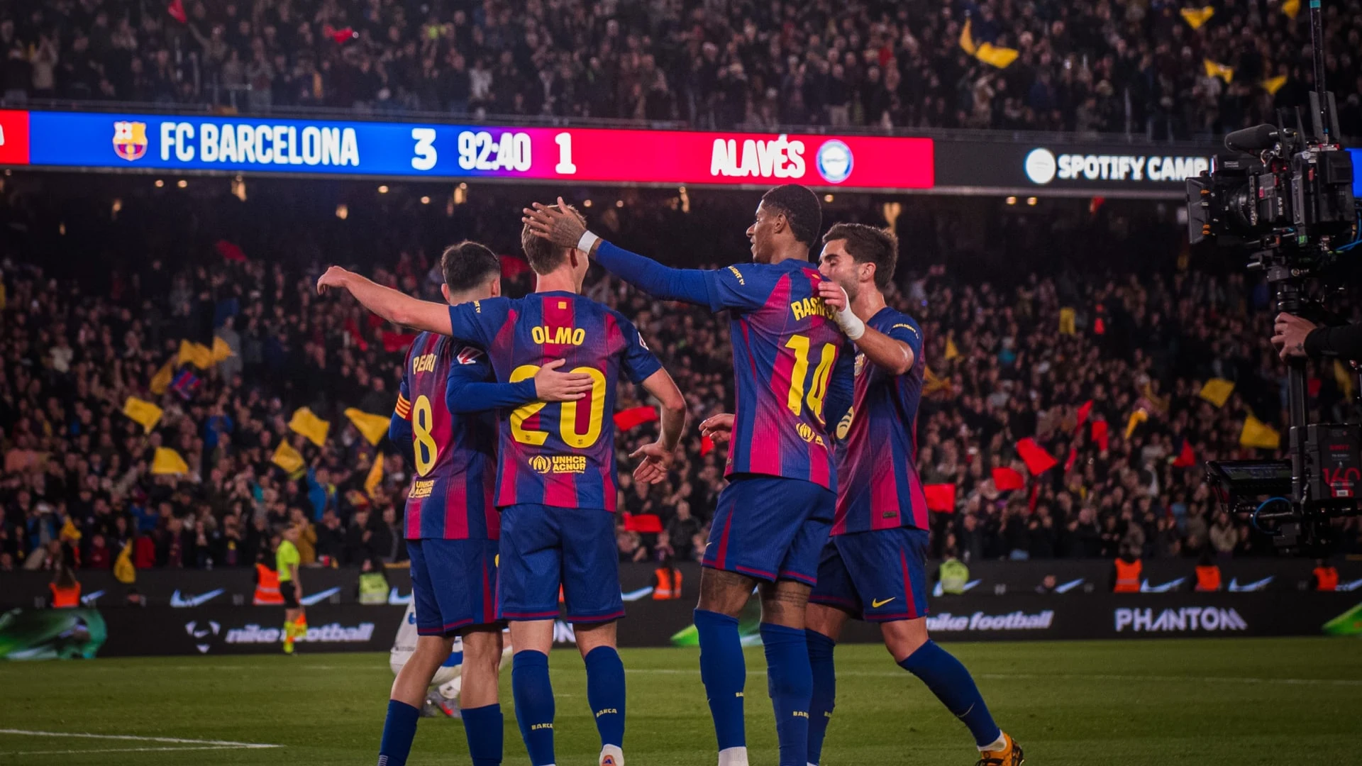 FC Barcelona players celebrating a goal, including Raphinha wearing jersey number 11.